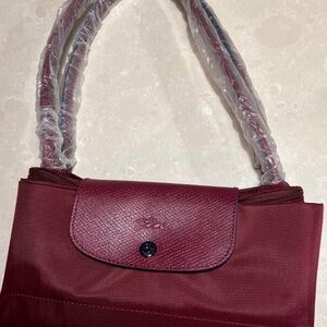 BNWOT and has the handle wrap Longchamp le pliage Burgundy Tote Bag